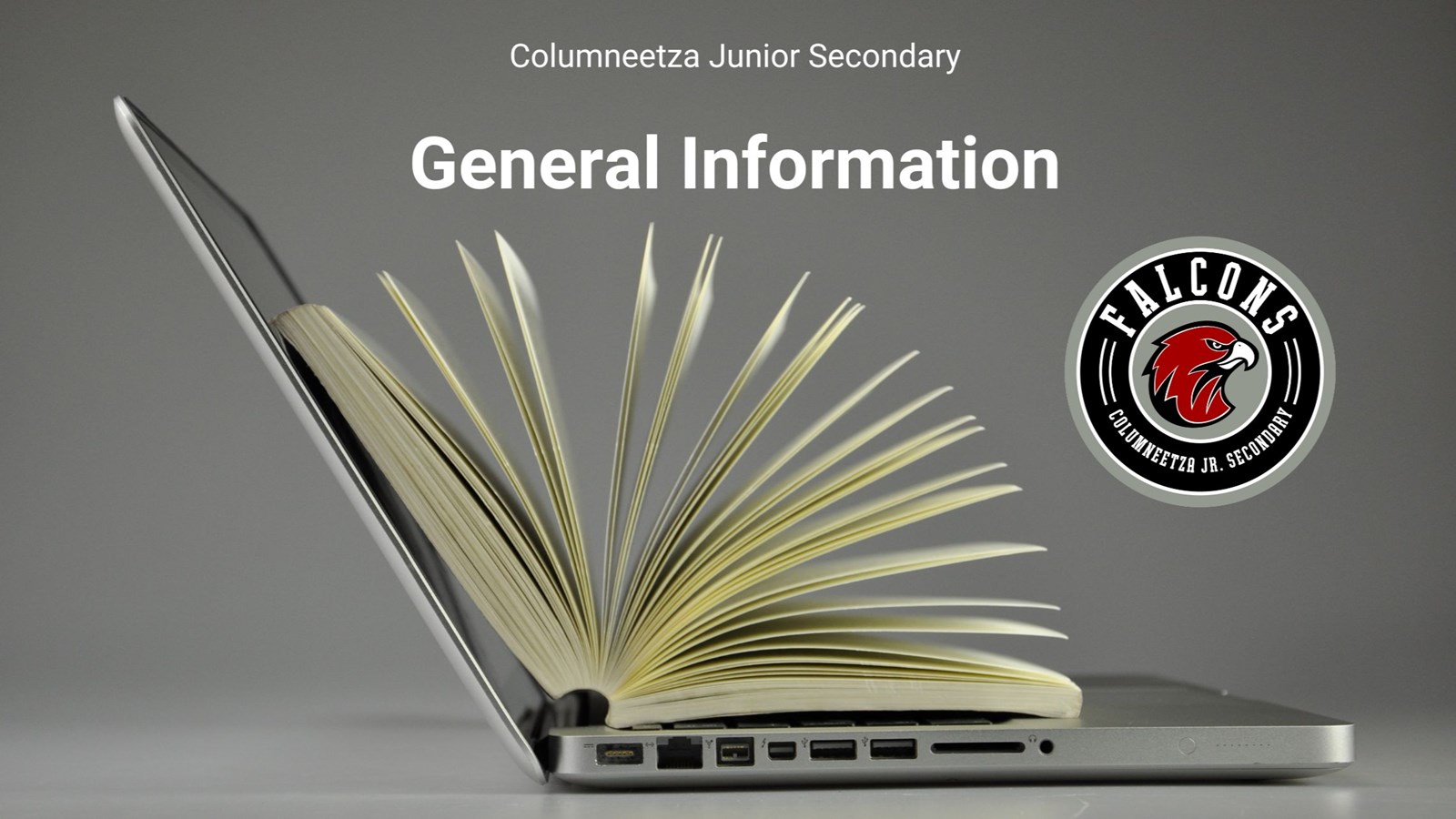 silver laptop with book open ontop